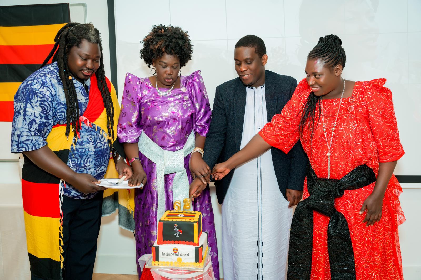 Community members cutting a Uganda independence cake