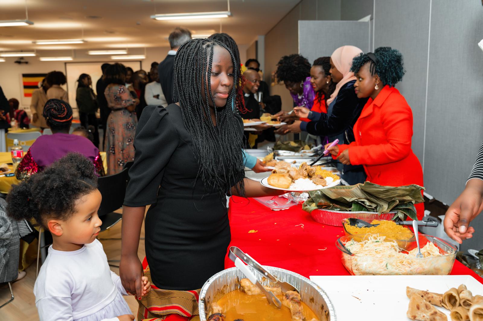 Families serving traditional food at a UCANI gathering