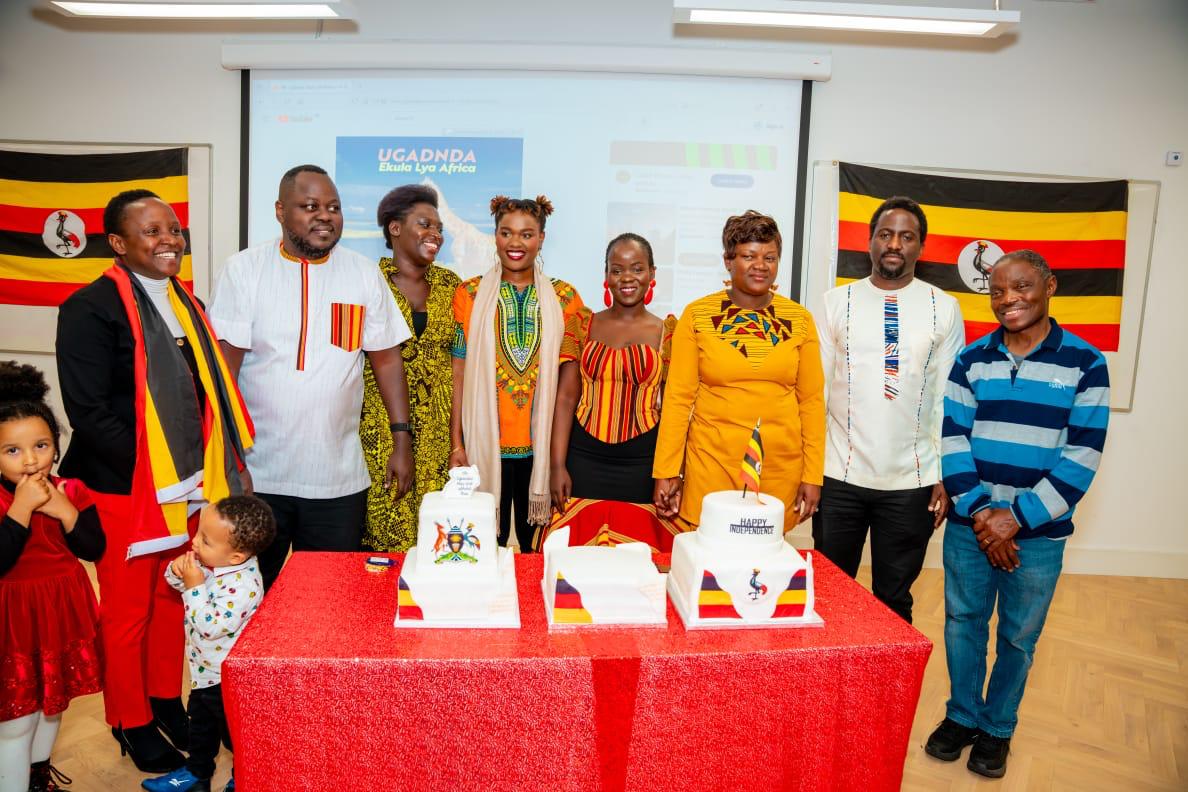 UCANI members gathered around celebration cakes and Uganda flags