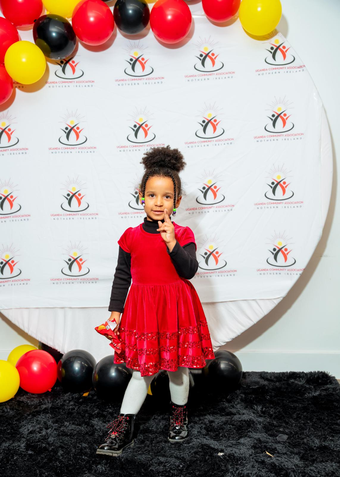 A young member in red posing at the UCANI photo wall