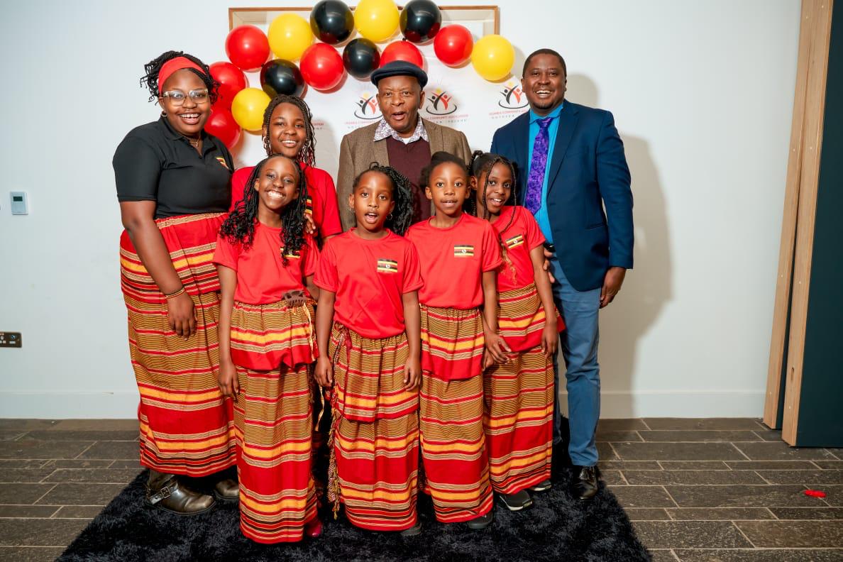 A family group posing in coordinated Ugandan attire